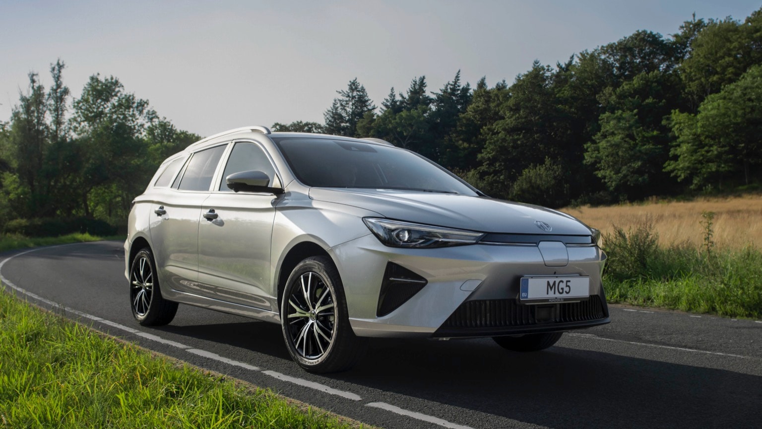 a silver car on a road