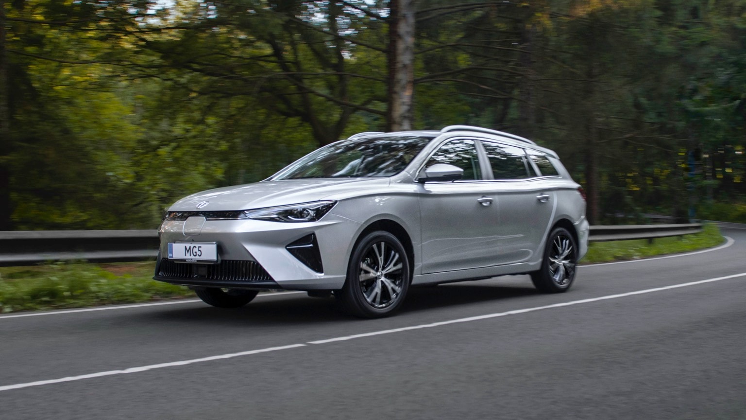 a silver car on a road