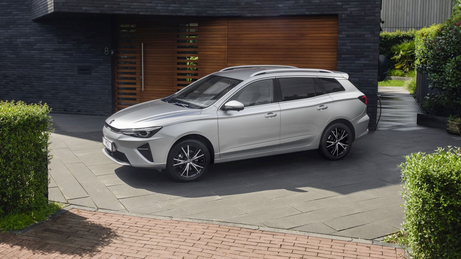 a silver car parked in front of a building