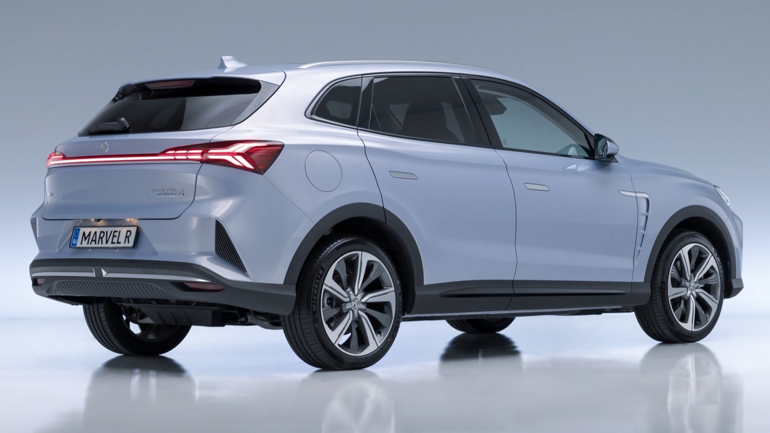 a silver suv with black wheels