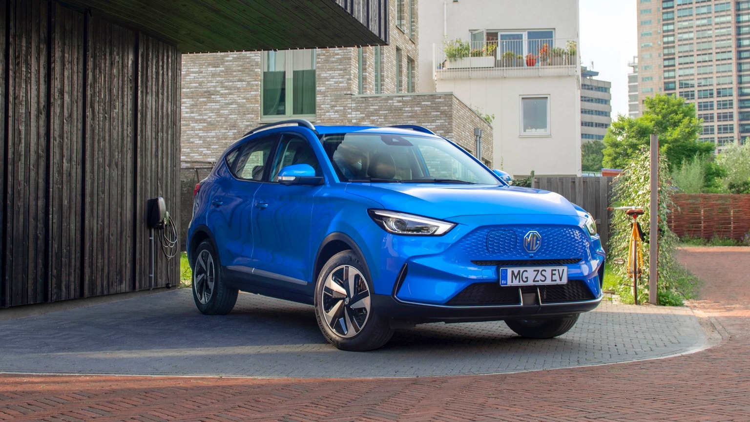 a blue car parked in front of a building