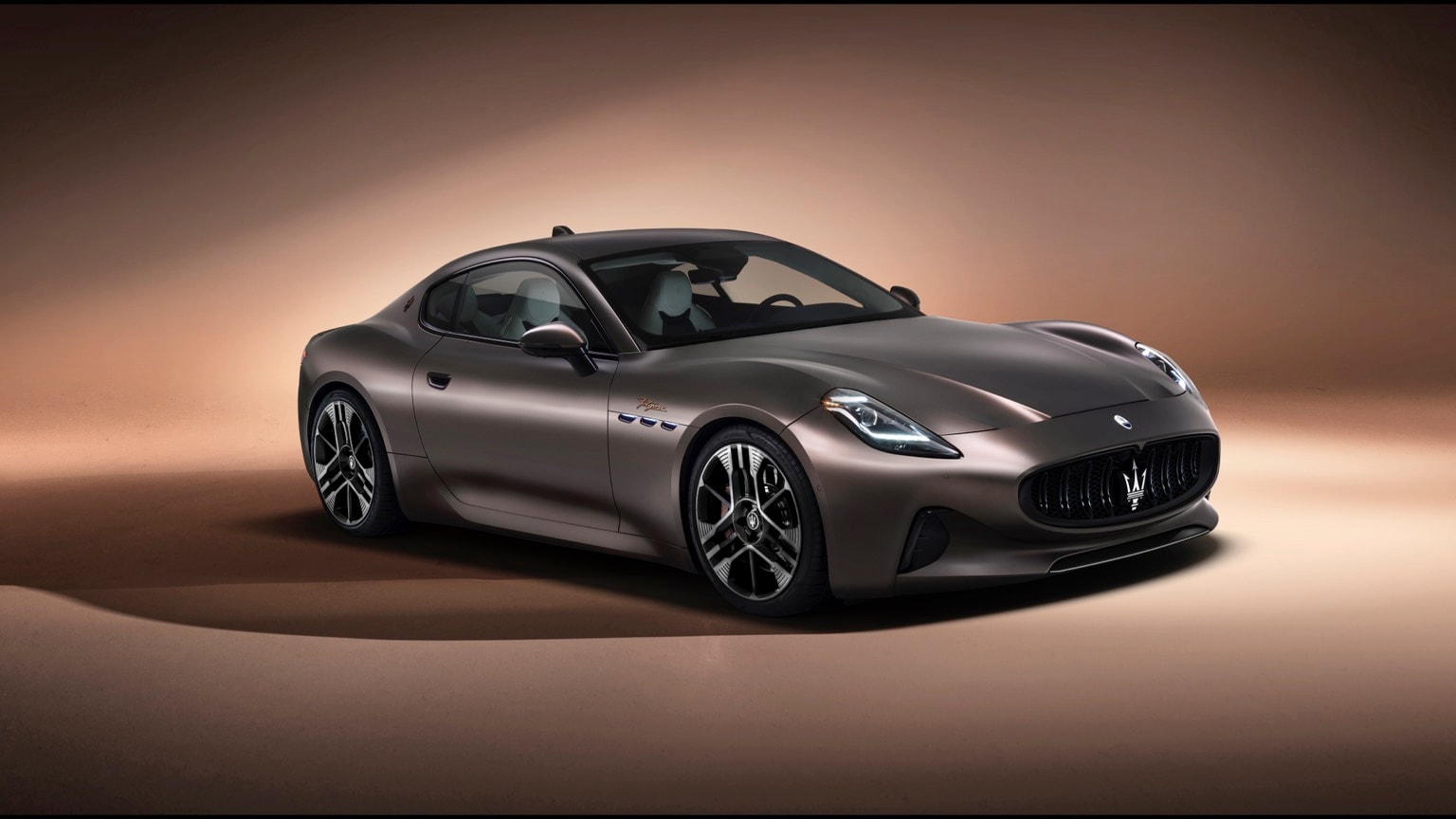 une voiture de sport noire sur une surface brune