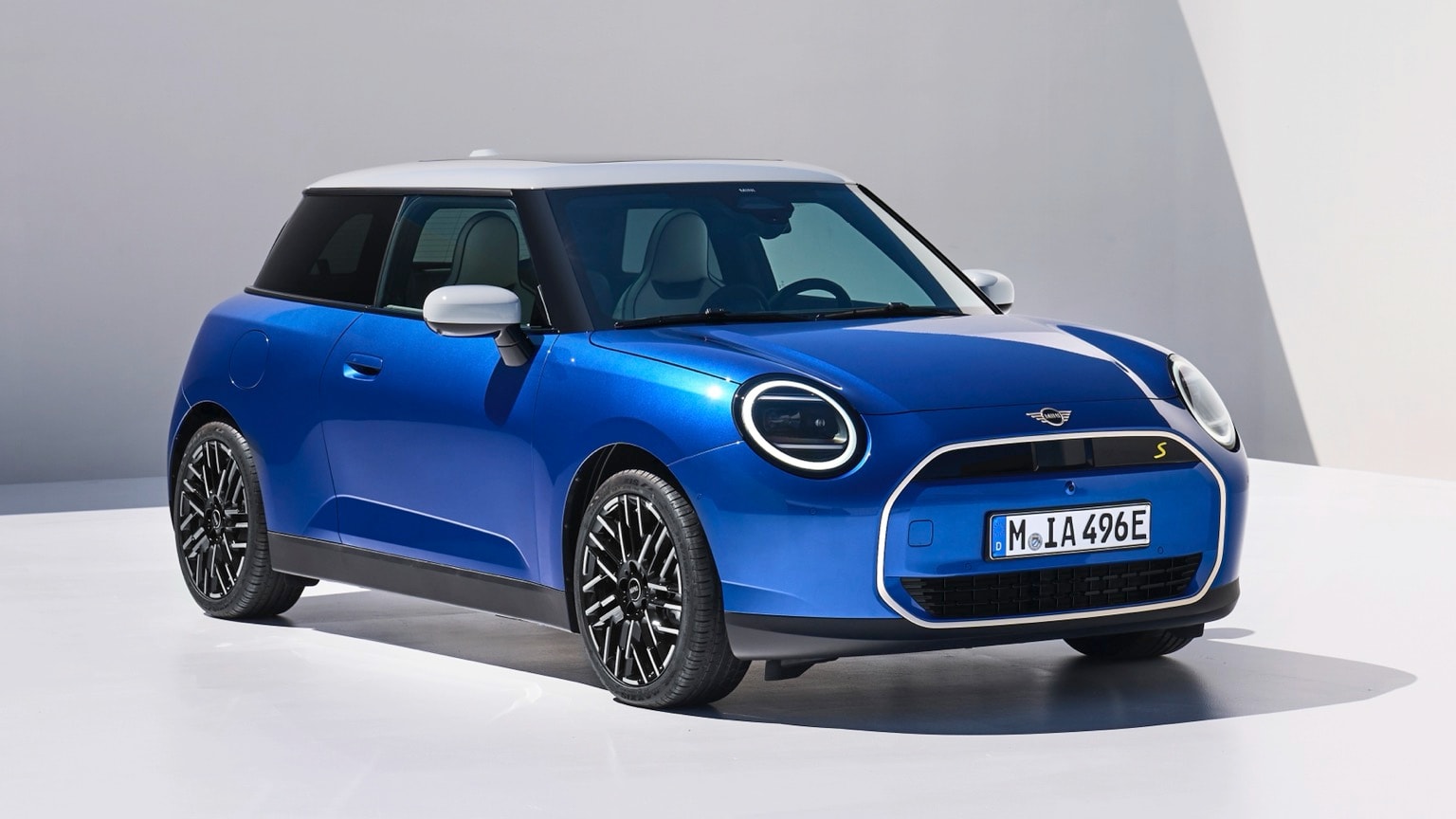 a blue car parked on a white surface