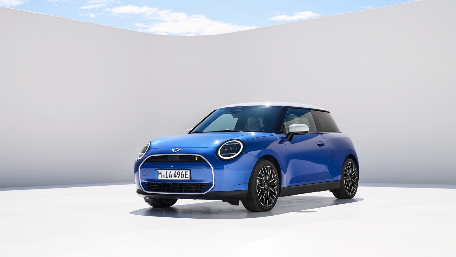 a blue car parked in a white room
