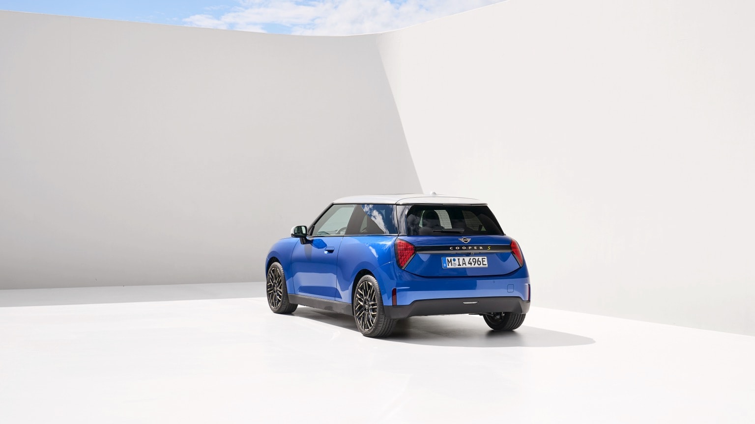 a blue car parked in a white room