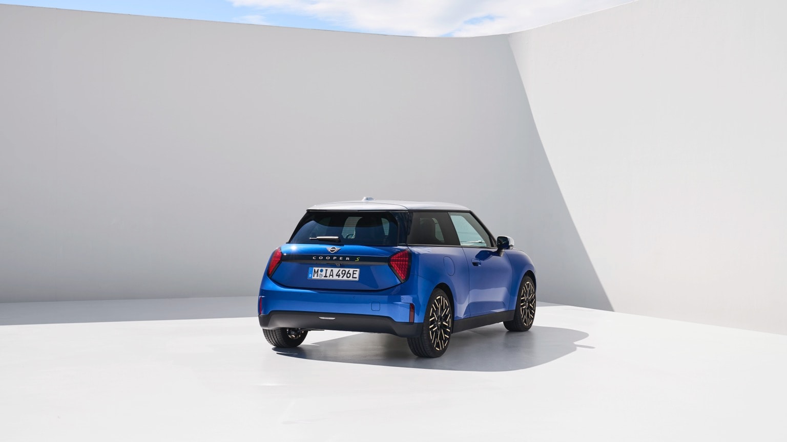 a blue car parked in a white room