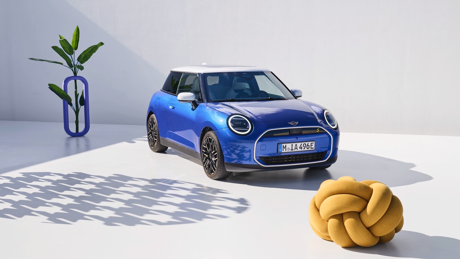 a blue car parked next to a yellow knot