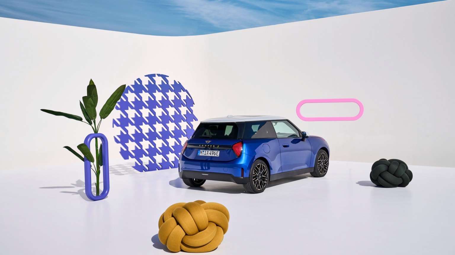 a blue car parked in a white room