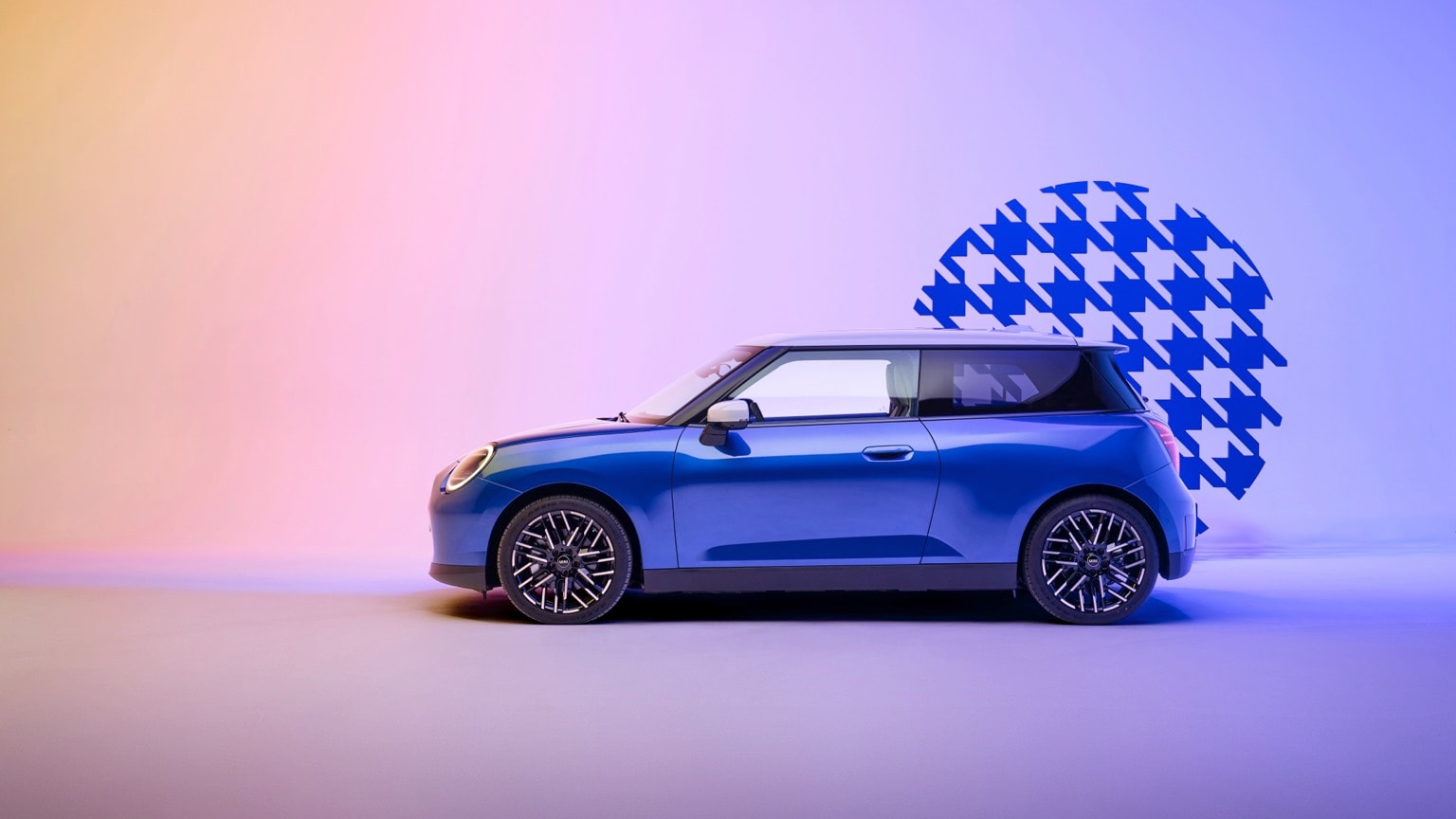 a blue car parked in front of a blue and pink background