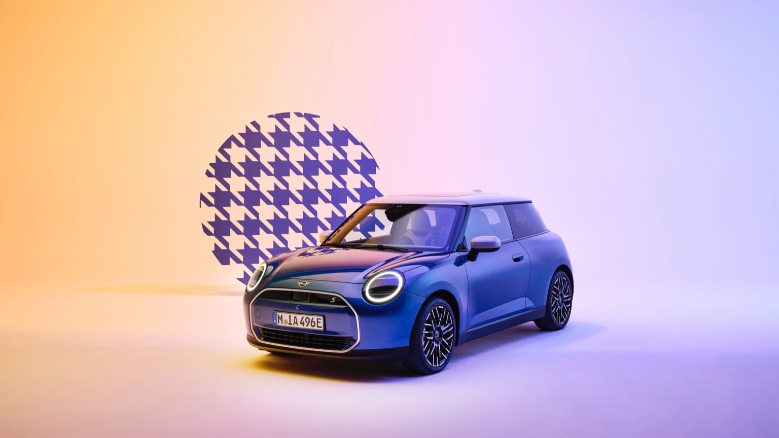 a blue car parked in front of a checkered wall