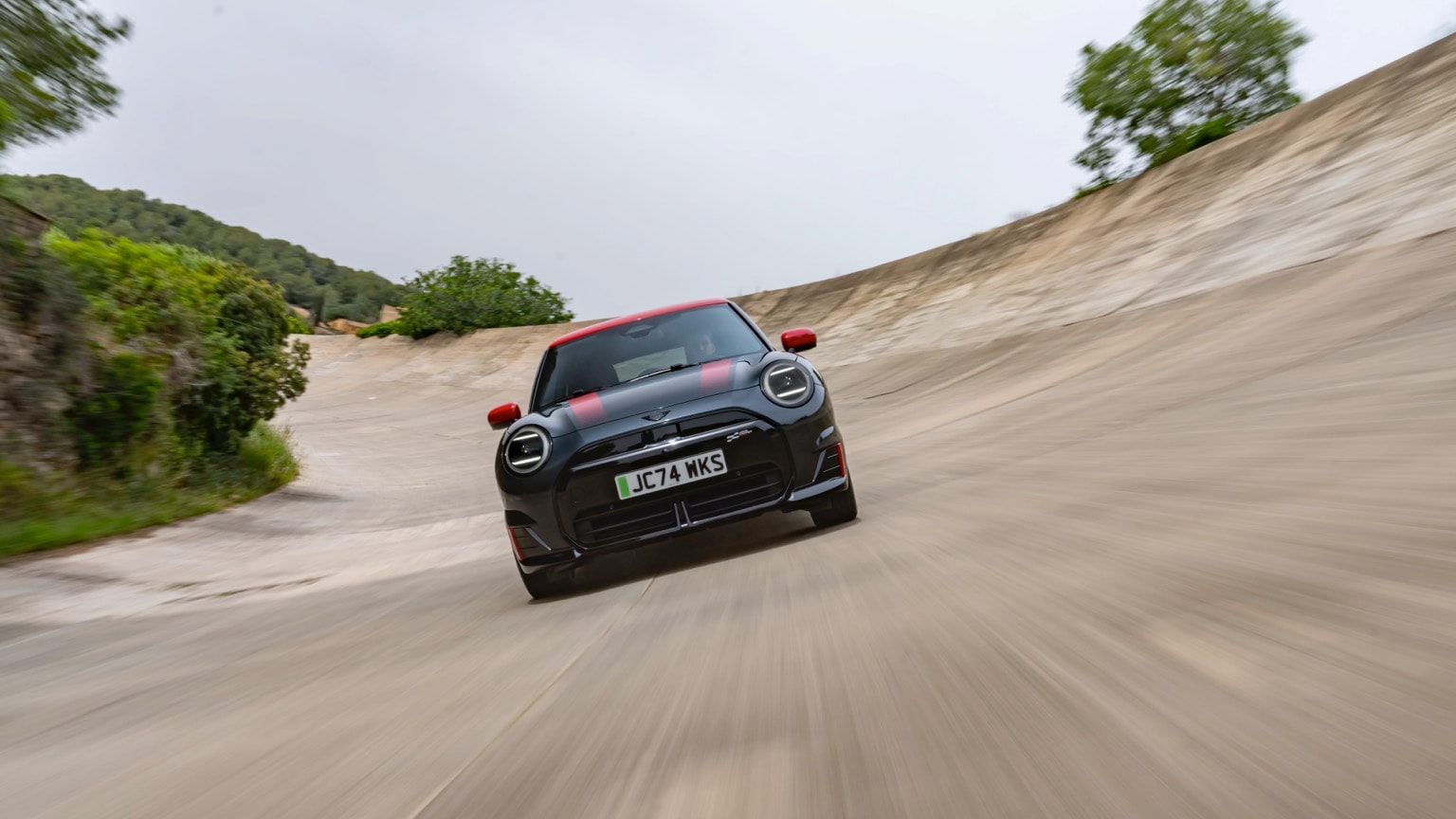 a black car on a dirt track