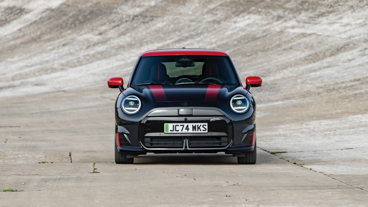 a black and red car on a road