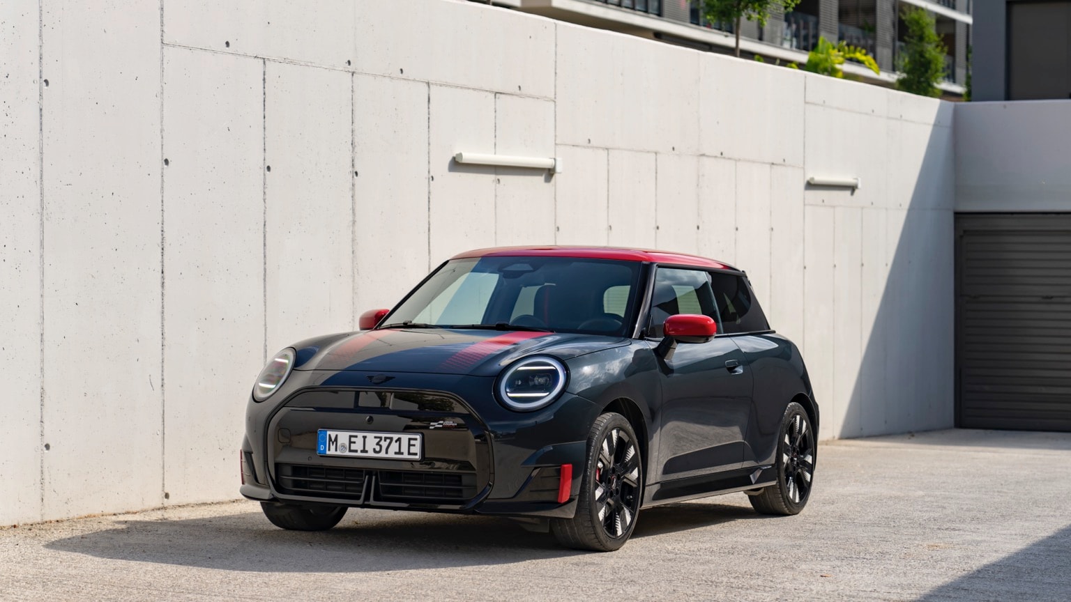 a black and red car parked on a concrete surface