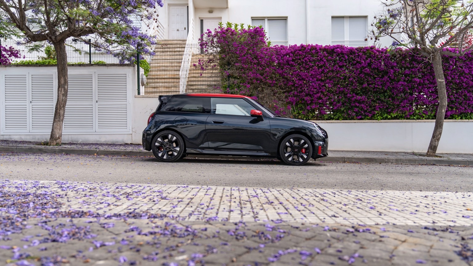 a black car parked on the side of a road