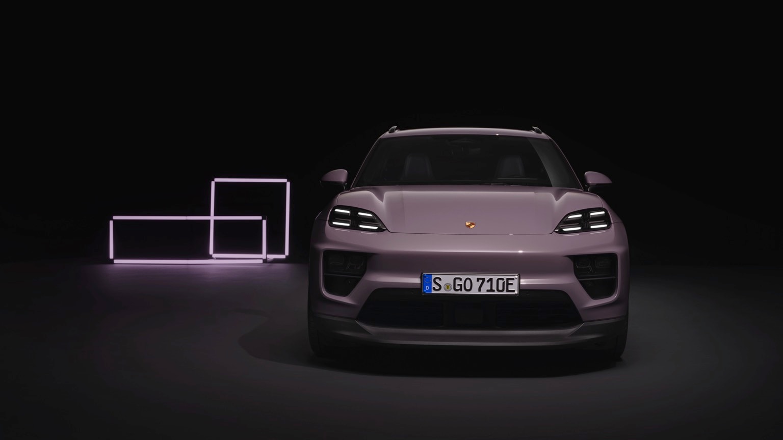 a purple car parked in front of a purple square object
