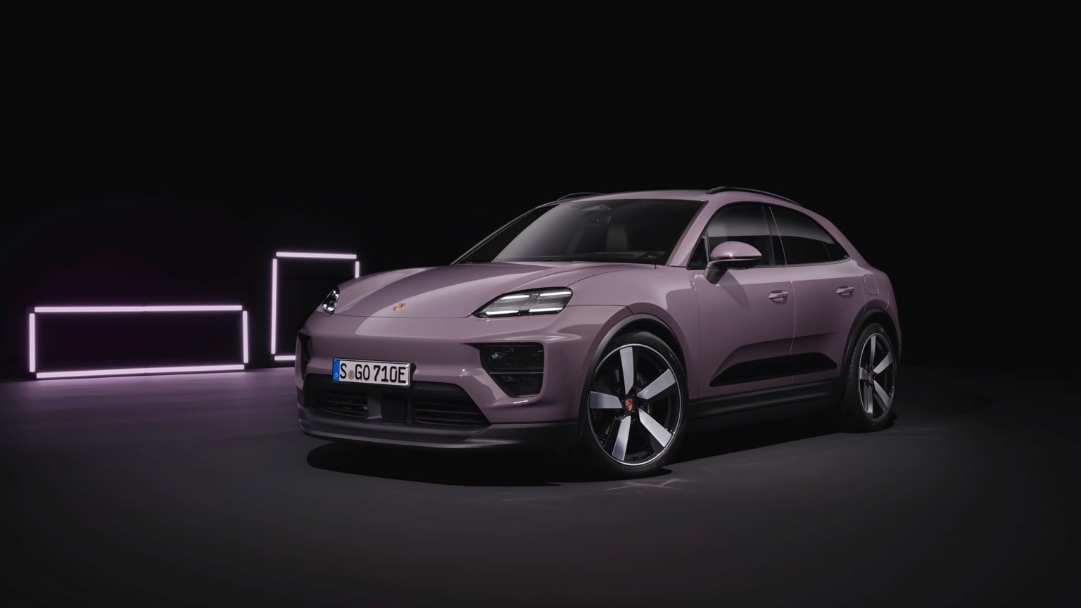 a purple car parked in a dark room