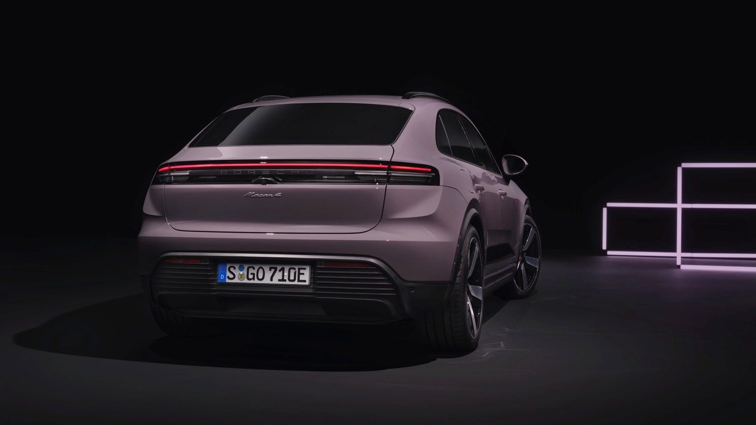 a purple suv in a dark room