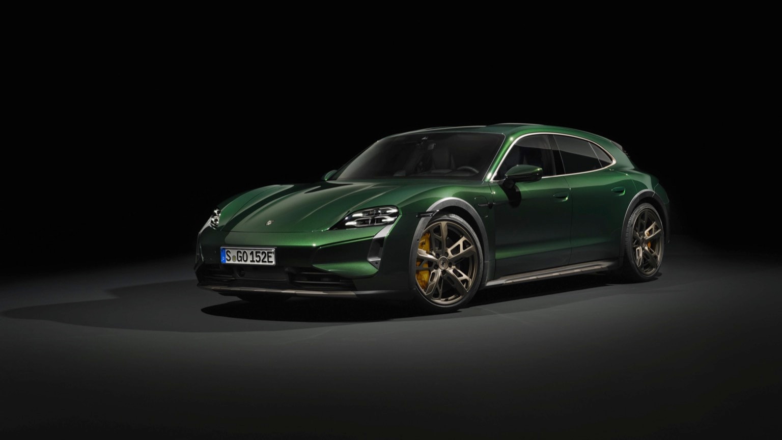 a green sports car with a black background