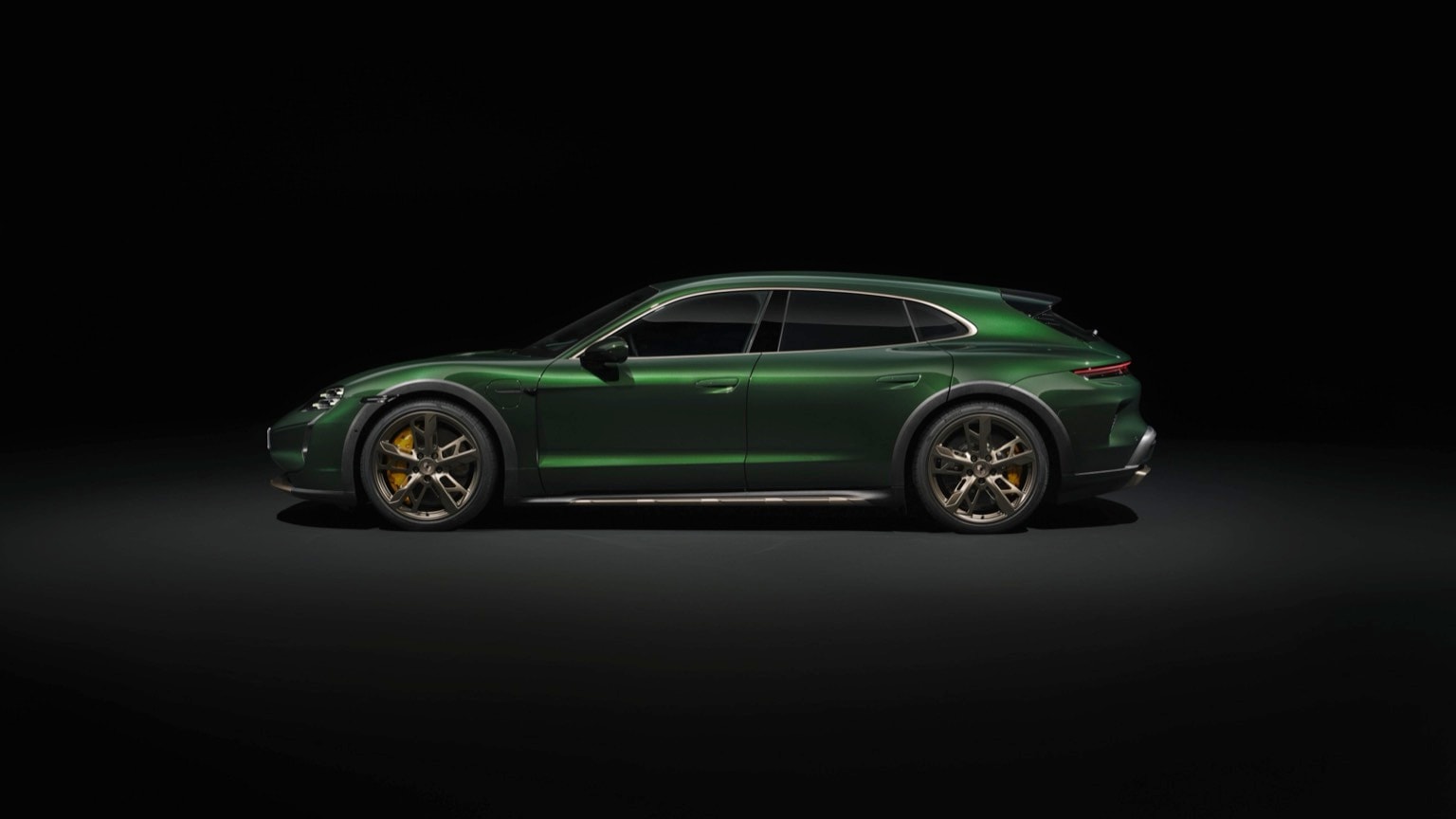 a green sports car in a dark room