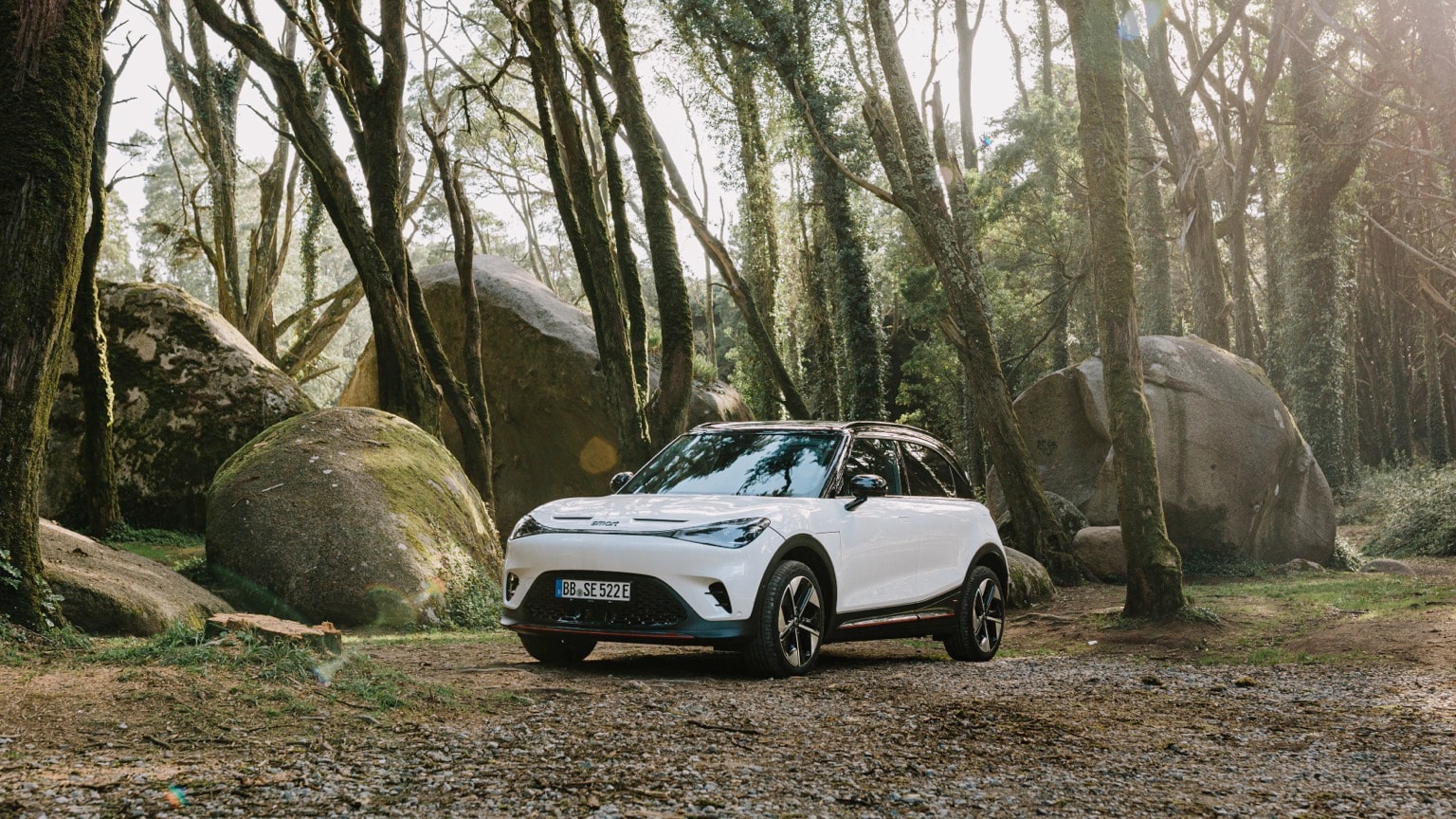 a white car parked in a forest