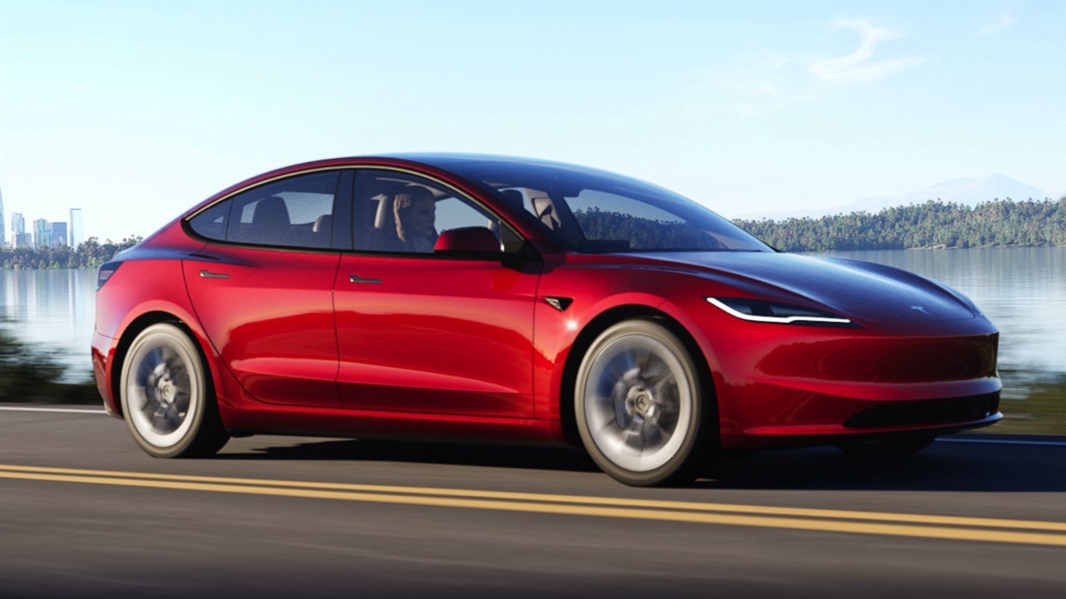 a red car driving on a road