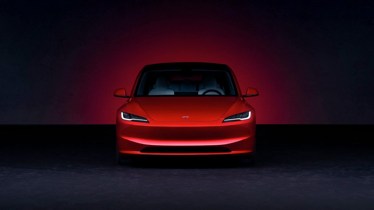 a red car in a dark room