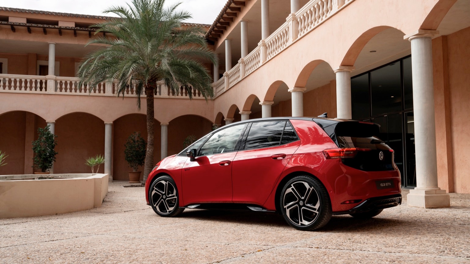 une voiture rouge garée devant un bâtiment