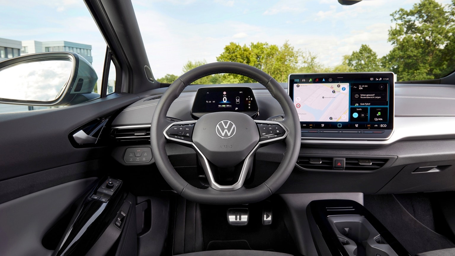 the interior of a car with a steering wheel and a screen